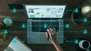 Laptop on a desk with an overlaid graphic of a digital network and avatars visualizing social commerce structures.