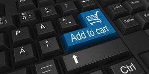 A blue Enter key with a shopping cart icon and the text "Add to cart" on a black computer keyboard.